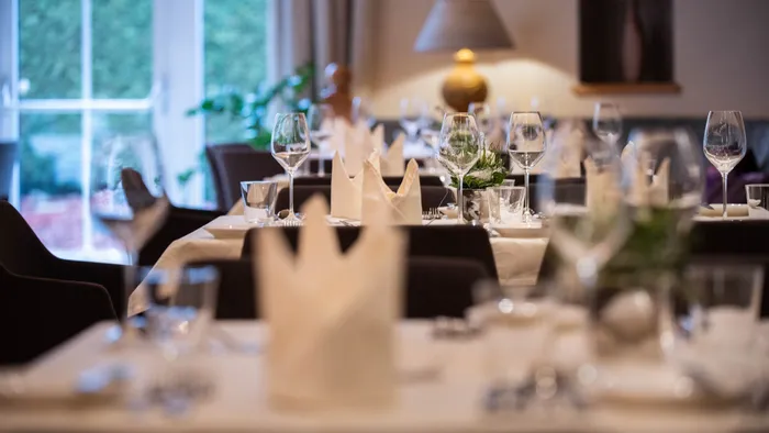 Elegant restaurant table setting with folded napkins and wine glasses