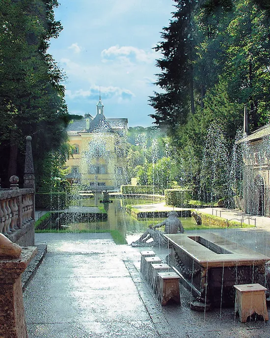 Historic fountain courtyard in Hellbrunn Palace gardens with statues and water jets