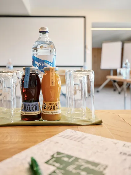 Konferenzraum mit Saftflaschen, Wasser und Gläsern auf einem Tisch